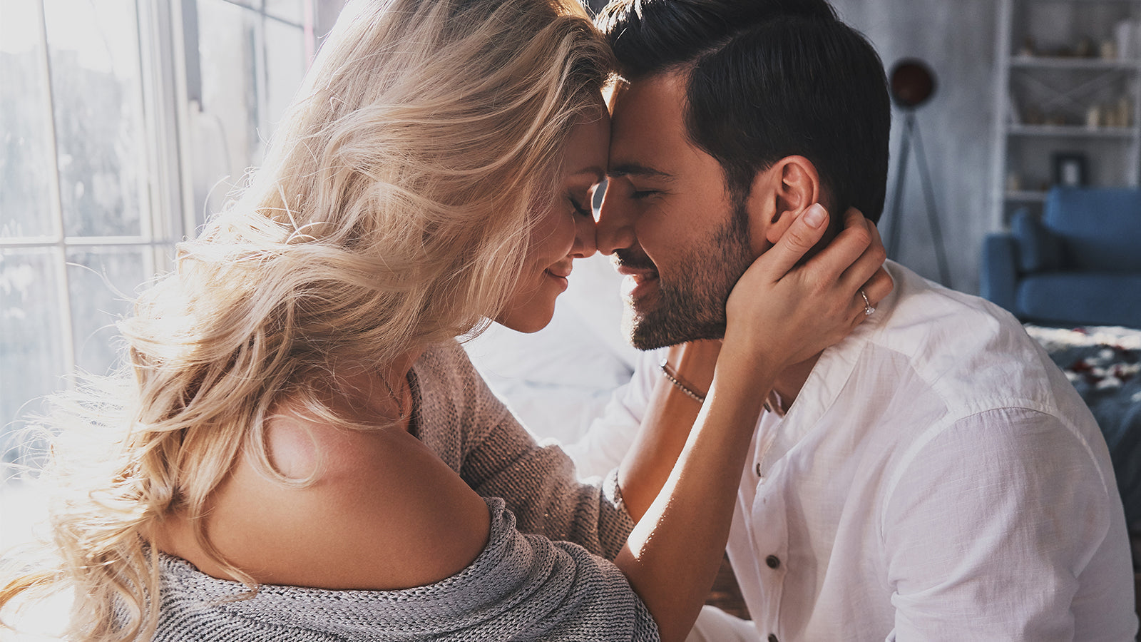 Romantic couple embracing, highlighting an engagement ring on the woman's hand