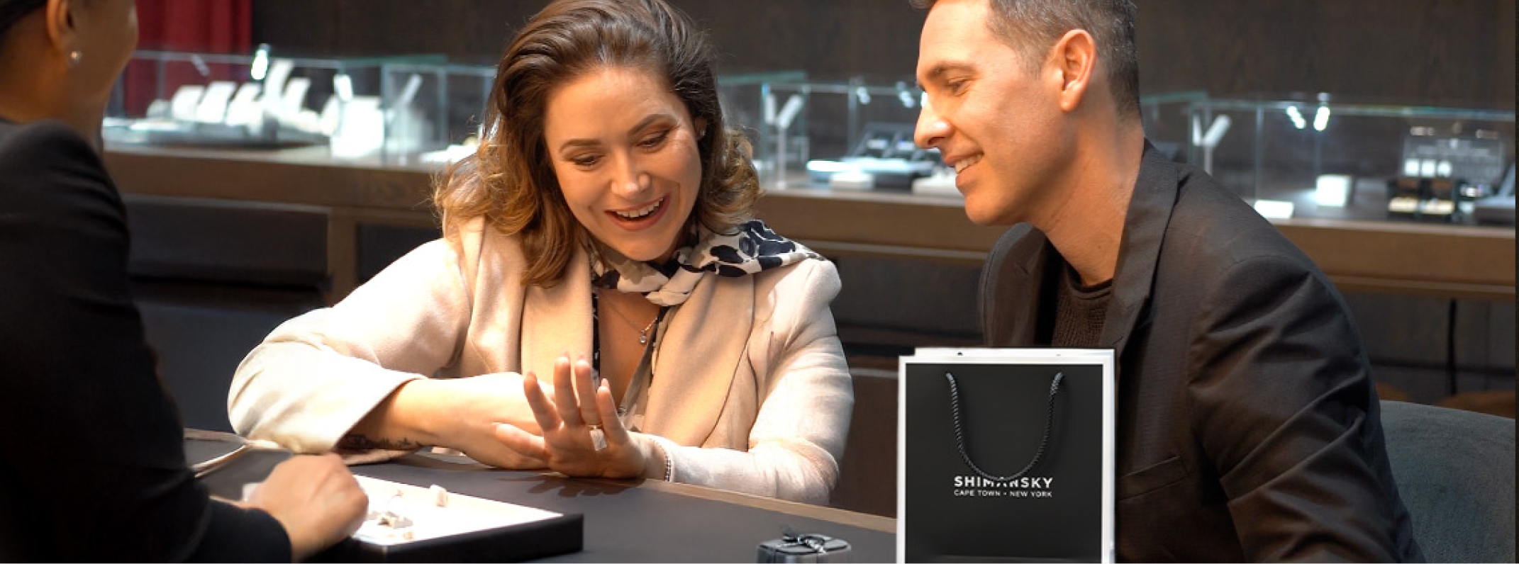 A Jewelry design consultation image of a couple with a Shimansky consultant in the Shimansky jewelry store at the V&A Waterfront store in Cape Town, South Africa.