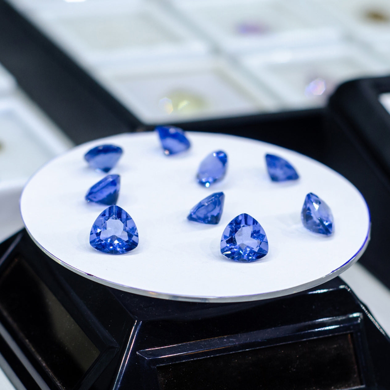 Shimansky Cut and Polished Tanzanite gems on a scale
