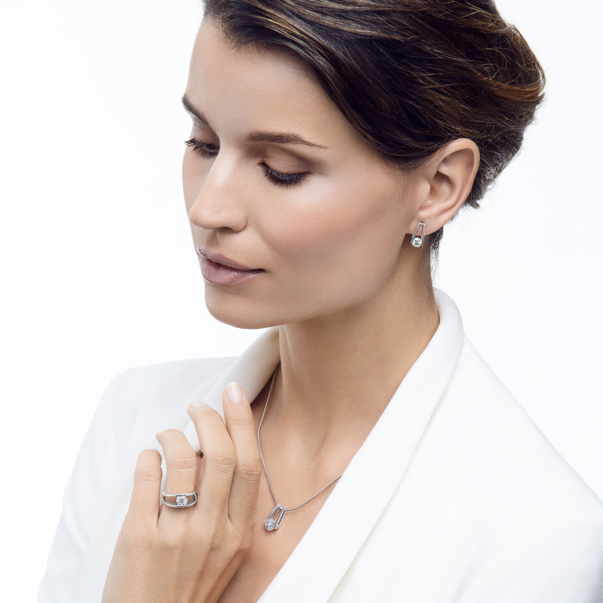 Woman in white wearing the iconic Shimansky Millennium collection set, earrings, pendant and ring