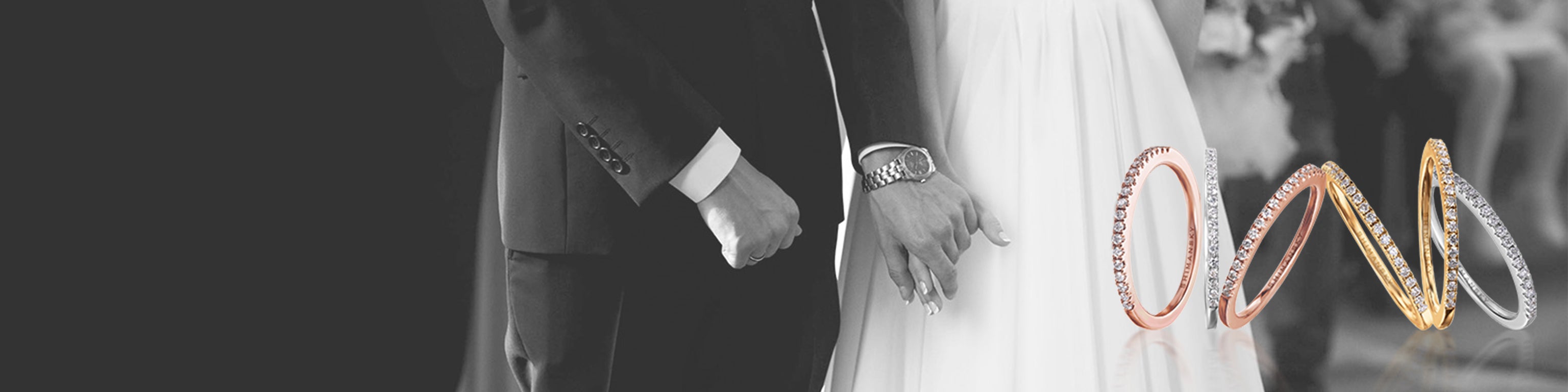 A couple holding hands, showcasing their Evolym wedding bands by Shimansky, symbolizing eternal love and commitment.