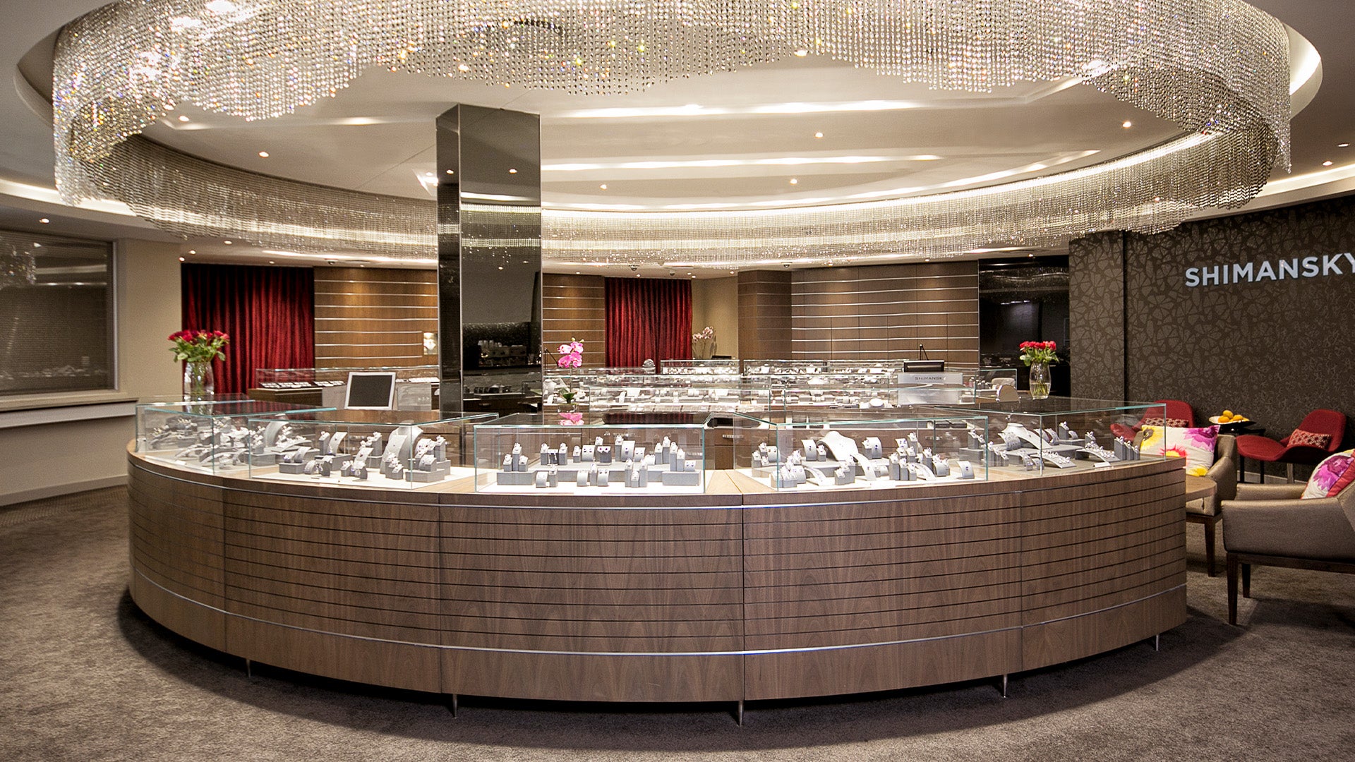 A grand circular display case brimming with exquisite jewelry at the Cape Town Diamond Museum, showcasing luxury and elegance.