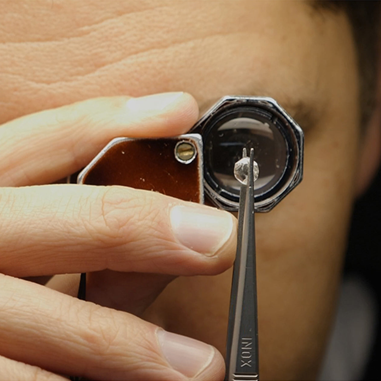 Shimansky jeweler holding a diamond inspection kit.