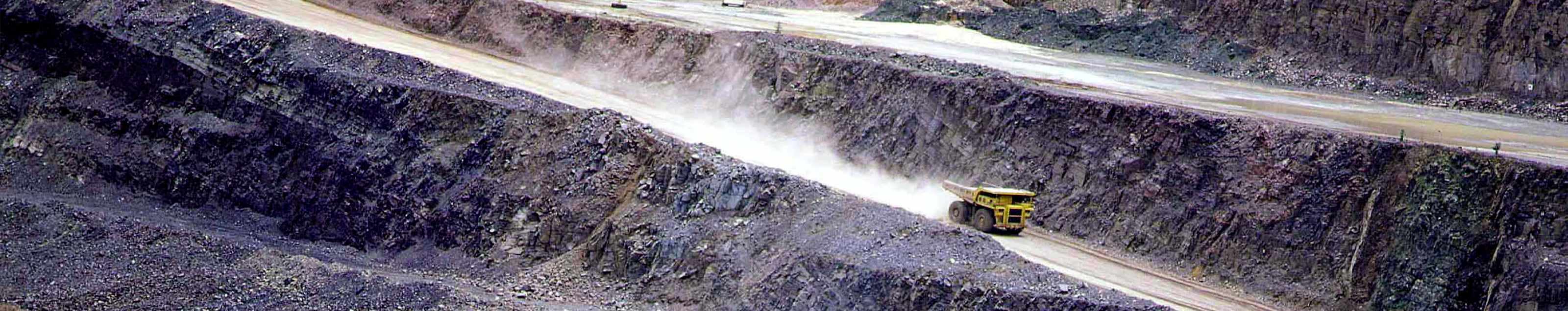 A truck traverses a mountainous path, illustrating Shimansky's focus on responsible and ethical mining processes