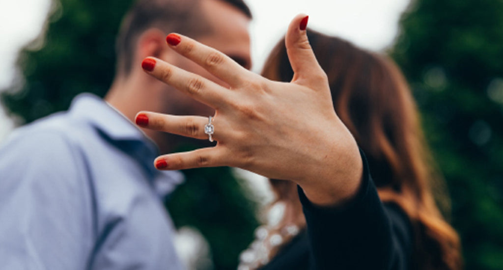 A couple gazes into each other's eyes, hands intertwined, radiating love and connection in a serene moment.