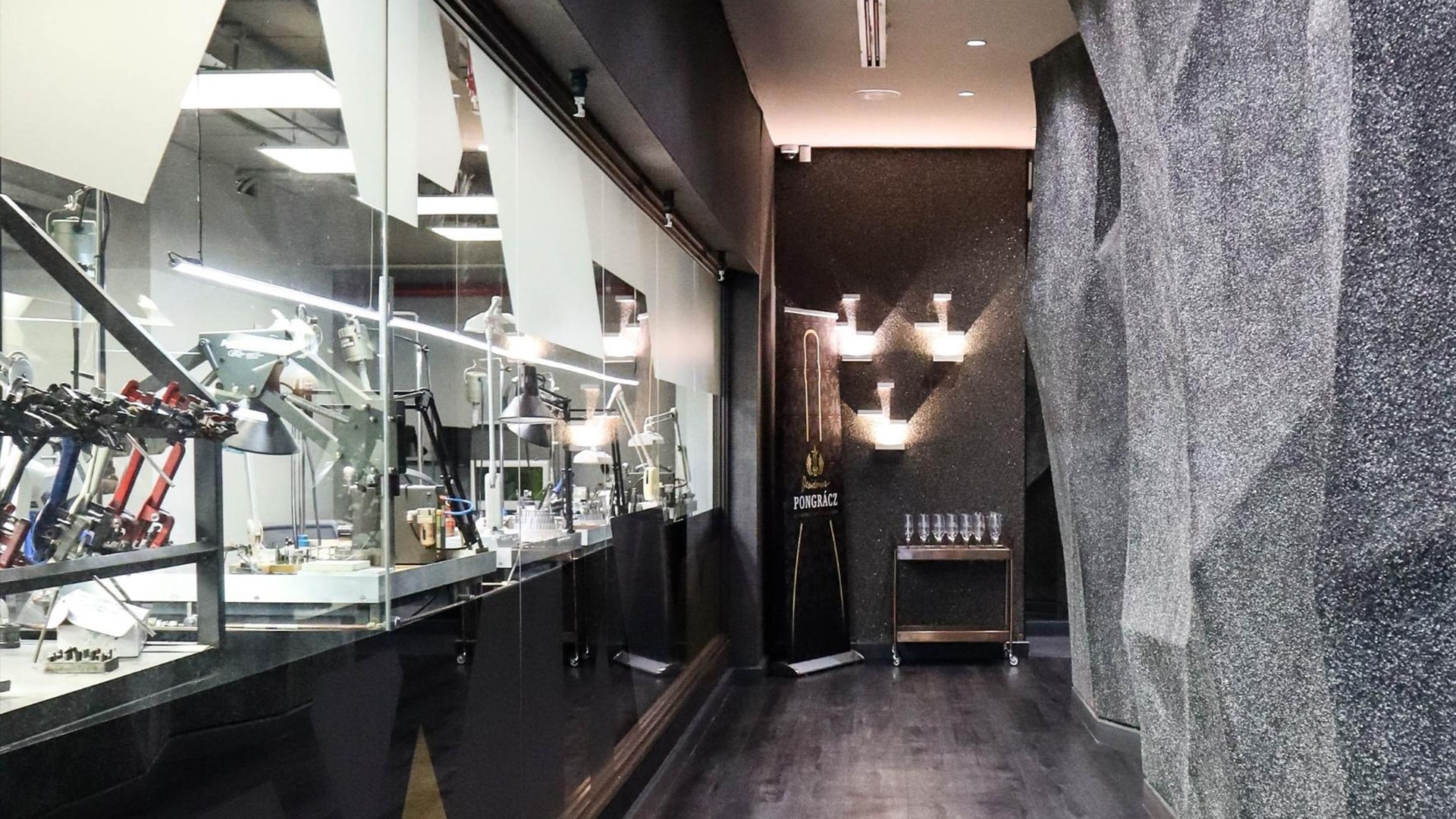 A sleek, modern hallway adorned with glass and metal, showcasing the elegance of the Shimansky Rockwell Showroom.