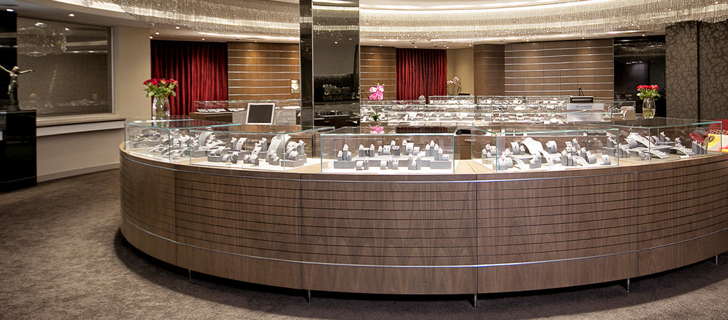 An elegant display case filled with diverse jewelry pieces, located at Shimansky Clock Tower in Cape Town's Waterfront.