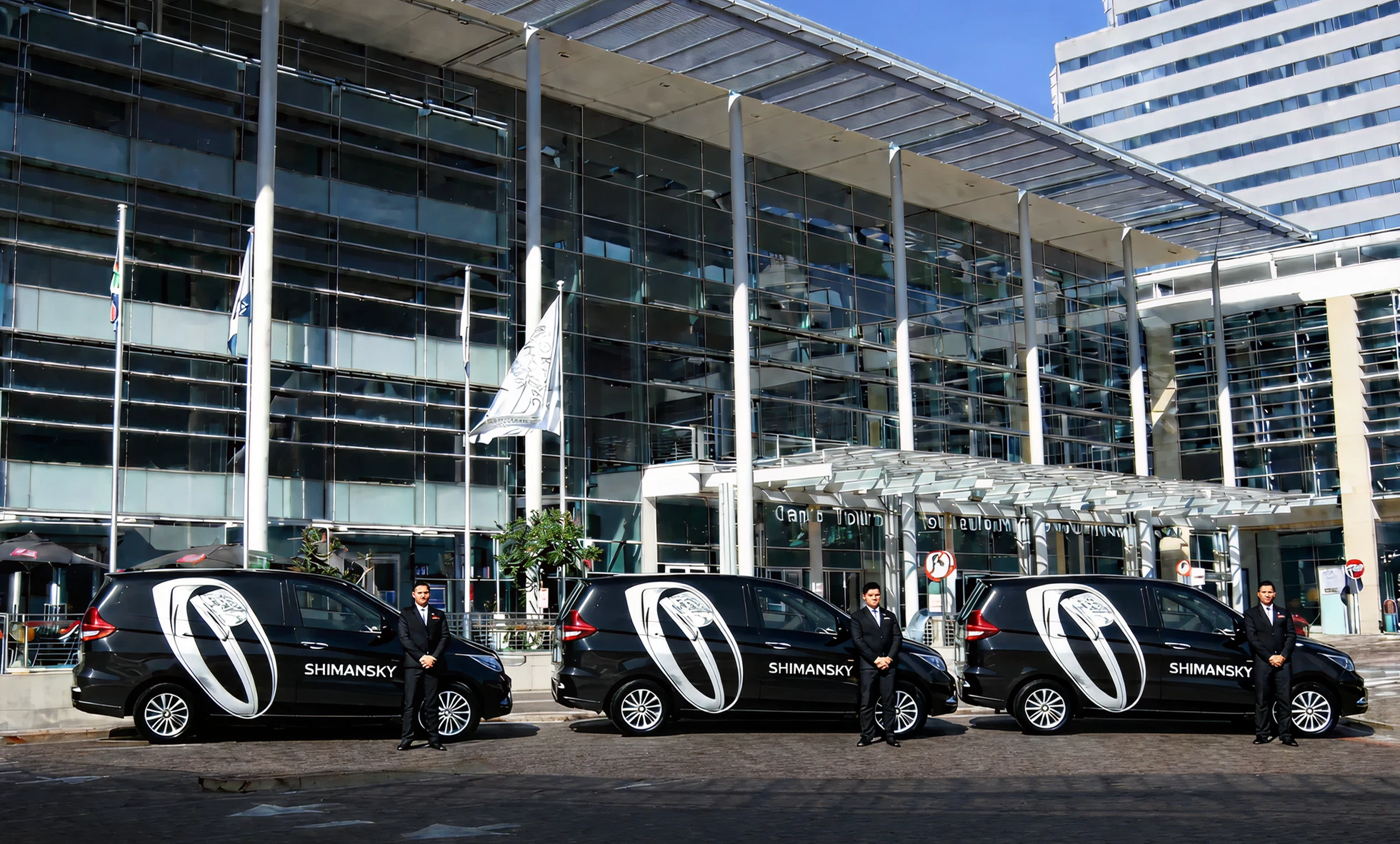Shimansky with branded luxury vehicles outside the Cape Town International Convention Centre, representing South African gemstone heritage, in-house craftsmanship, and fine diamond and tanzanite jewelry.