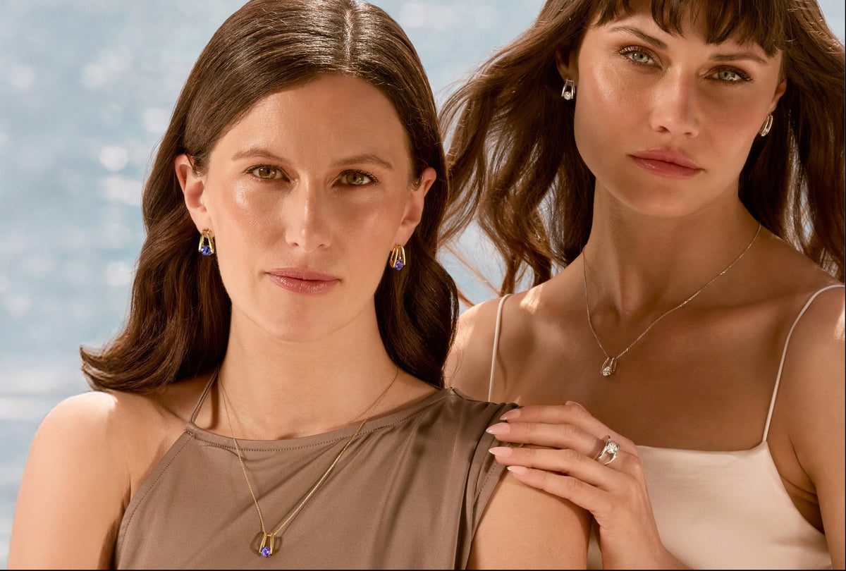Two models wearing matching Tanzanite and diamond jewellery from the Shimansky Iconic Millennium Collection.
