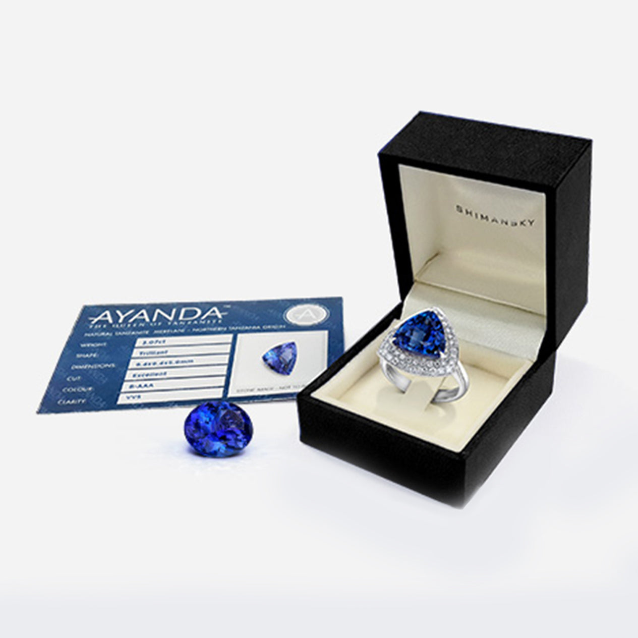 An exquisite Tanzanite ring featuring a central diamond, elegantly presented in a luxurious box with grading details