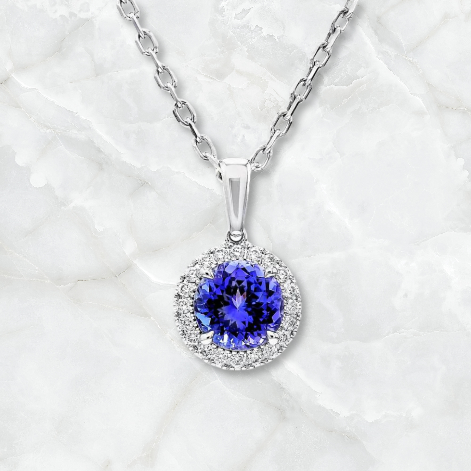 Exquisite Shimansky Tanzanite and diamond pendant elegantly displayed on a pristine white marble surface, showcasing luxury and sophistication.