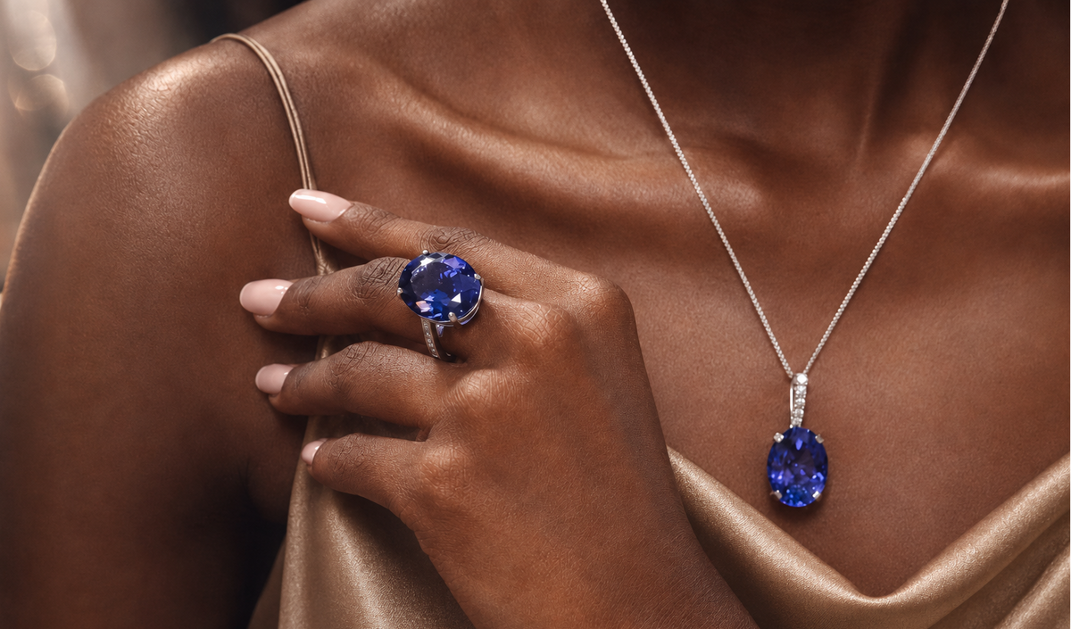 Shimansky large oval claw-set Tanzanite shown close on a hand, with a matching large oval claw-set Tanzanite matching pendant