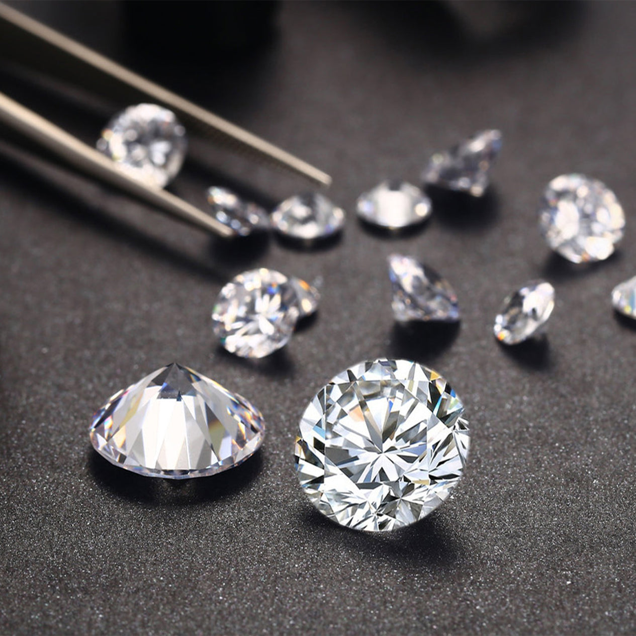 A luxurious display of sparkling diamonds rests elegantly on a table beside a pair of gleaming tweezers.