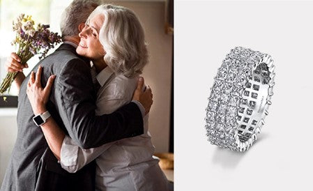 A couple embraces joyfully, showcasing their Shimansky infinity ring, symbolizing eternal love on their anniversary.