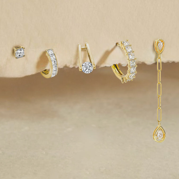 Exquisite Shimansky earrings featuring four unique designs adorned with gold and sparkling diamonds. A true luxury statement.