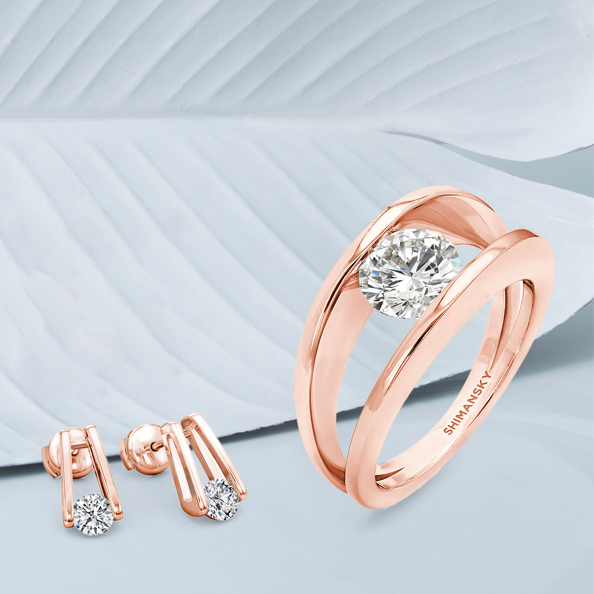 Stunning rose gold Shimansky Millennium ring paired with diamond earrings, epitomizing sophistication and glamour.